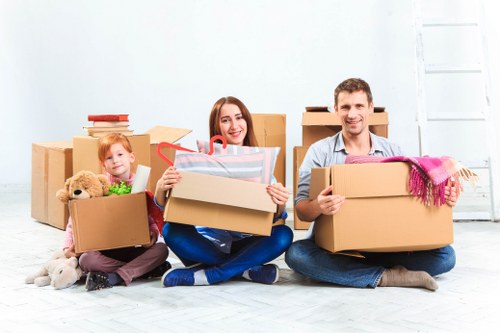 Removal team beginning a move with packed boxes and furniture