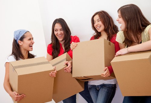 Removal van and moving team in a Colliers Wood street setting