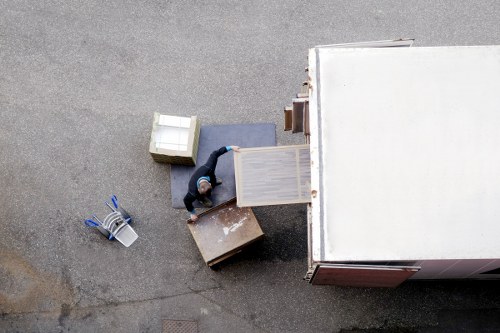Team member wearing PPE while loading items into a removals vehicle