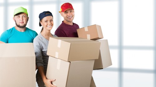 Local removals van near flats and terraces in Colliers Wood
