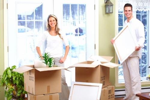 Loading household furniture into a removals van in Colliers Wood