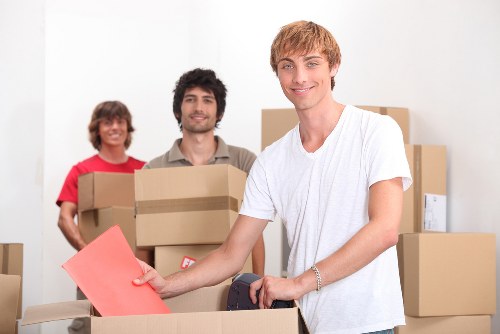 A small flat relocation with boxes and furniture in a busy local street